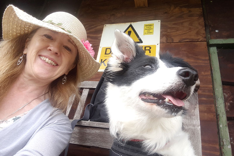 karen owner of tails and whiskers with a border collie